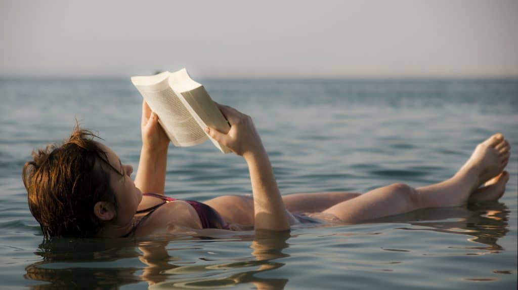The Dead Sea woman reading a book
